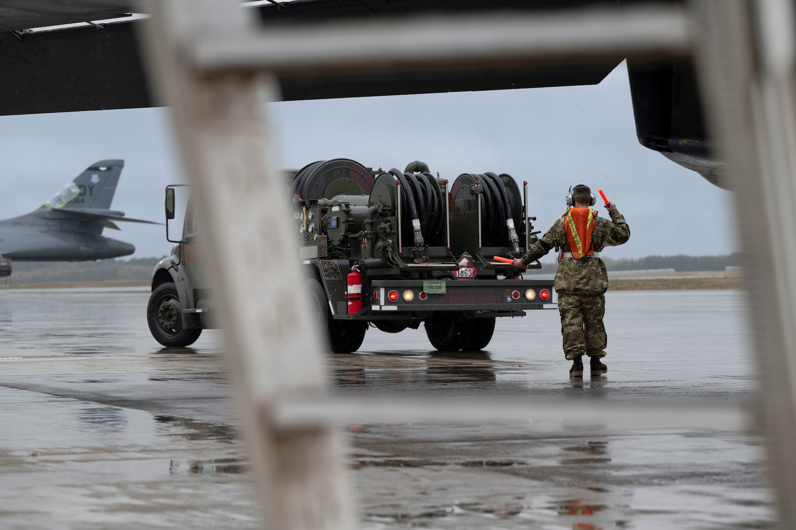 An airman performs maintenance on a B-1 bomber aircraft