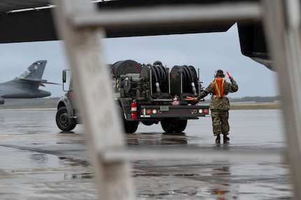 An airman performs maintenance on a B-1 bomber aircraft