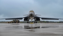 An airman performs maintenance on a B-1 bomber aircraft