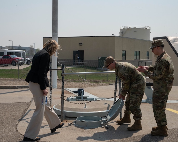 Tech. Sgt. Taylor Smith (middle), the 372d Field Training Detachment Non-Commissioned Officer in charge, and Staff Sgt. Austin Joyner (right), an electromechanical team instructor in the 372d Field Training Detachment, show Rep. Julie Fedorchak the outside of a training launch facility on Minot Air Force Base, North Dakota, May 5, 2025. The training launch facility is used in tours to show prominent members of Minot and North Dakota an inert Minuteman III missile that is used to train Airmen. (U.S. Air Force photo by Airman 1st Class Wesley Davies)