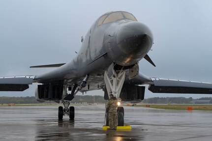 A B-1 bomber sits on the flightline in the rain