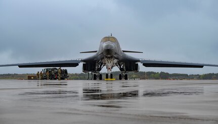 An airman performs maintenance on a B-1 bomber aircraft