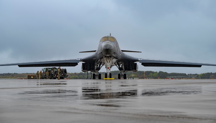 An airman performs maintenance on a B-1 bomber aircraft