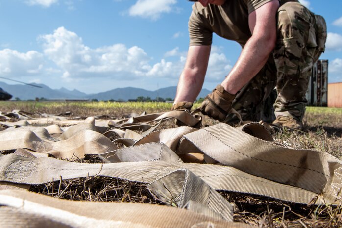 An Airman unravels a net