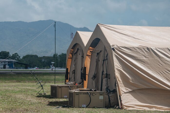 Two tents are set up for a forward operating site