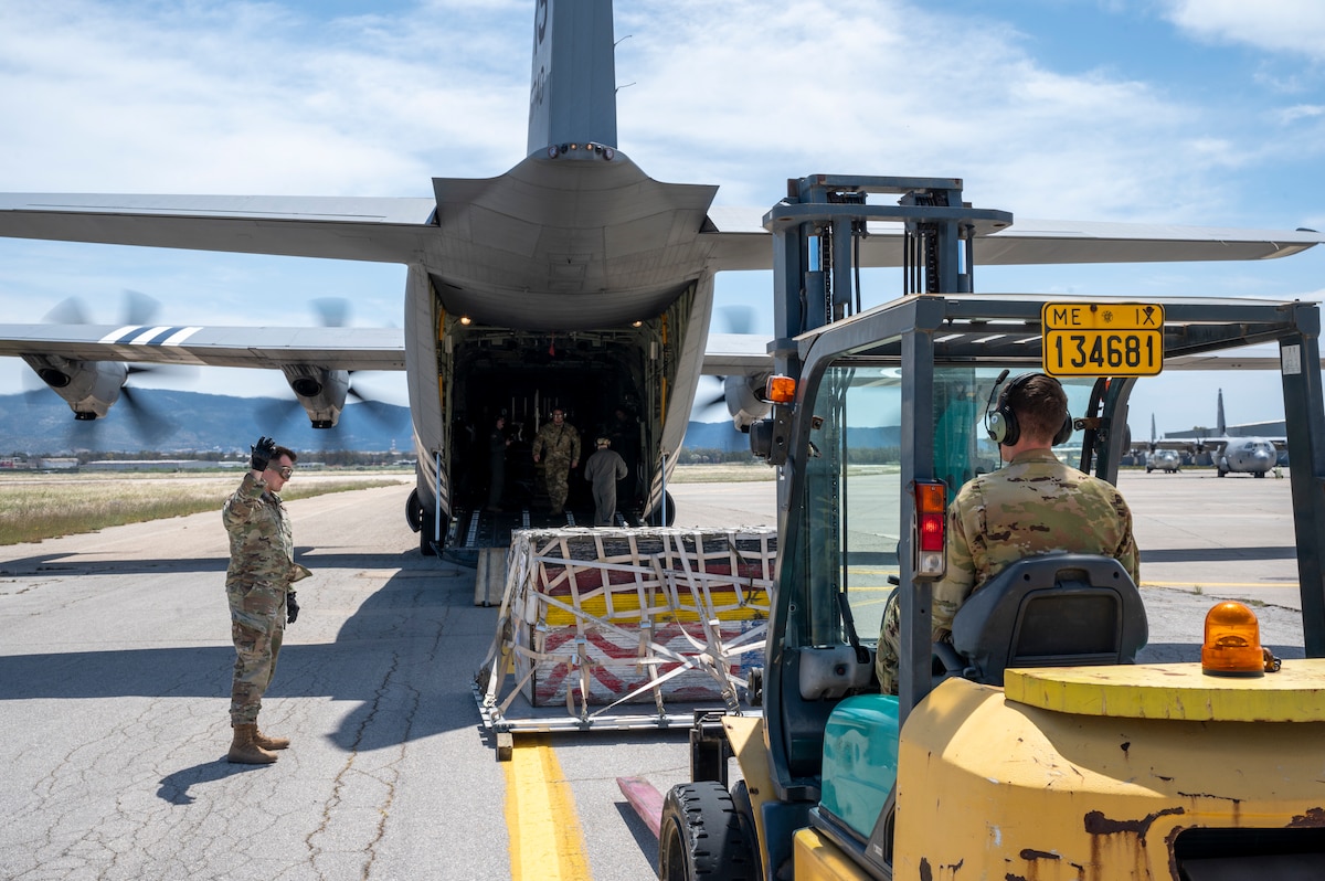 U.S. Air Force 2nd Lt. Jordan Von Seggern, a member of the 86th Airlift Wing’s Cross-Functional Airlift Support Personnel (CASPER) program, guides Tech. Sgt. Alexander Lauher, 37th Airlift Squadron instructor loadmaster, as he loads a pallet onto a C-130J Super Hercules as part of combat offload training during exercise Stolen Cerberus XII at Elefsina Air Base, Greece, May 1, 2025.