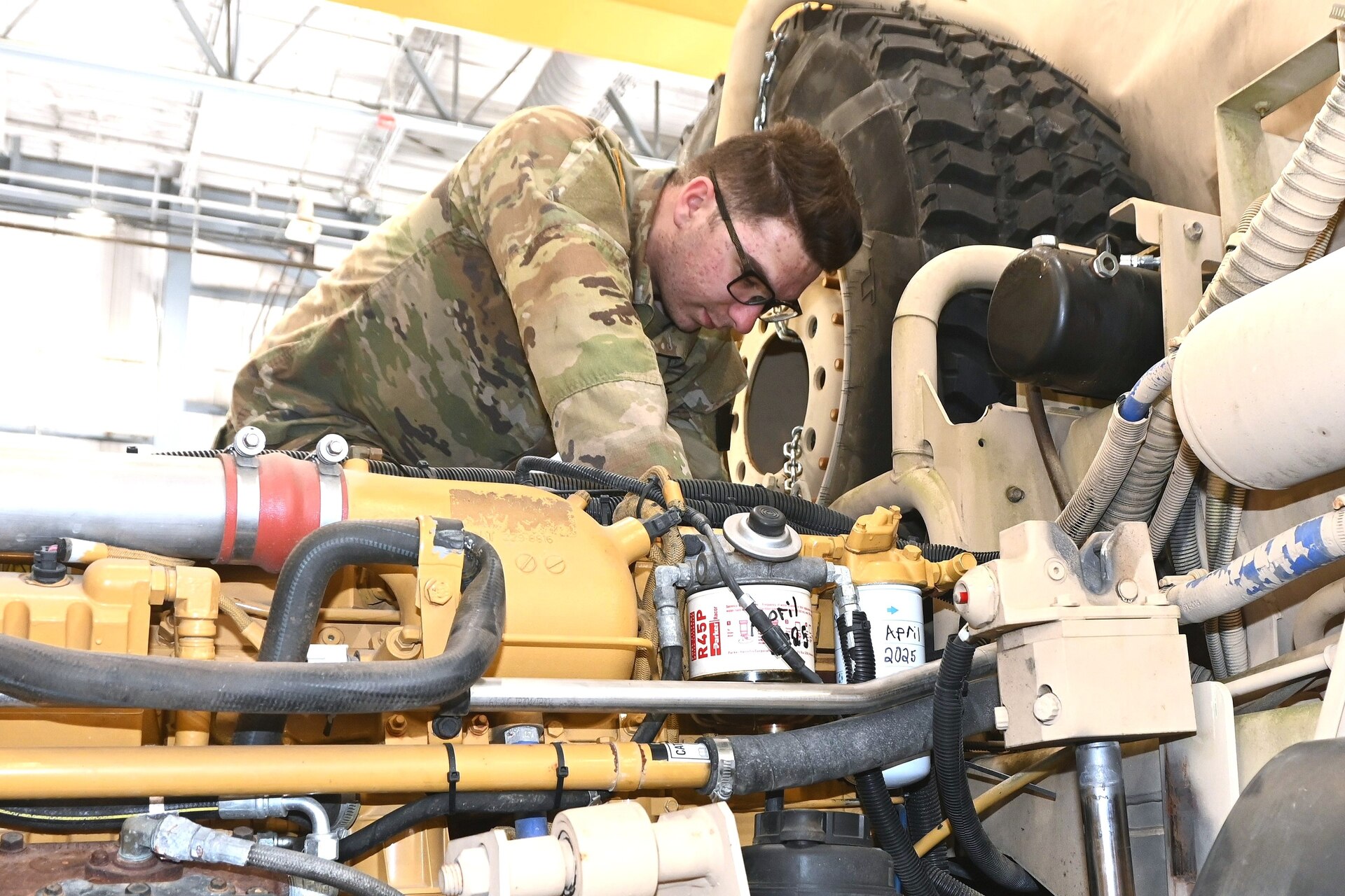 Pfc. Scott Gabner works on a vehicle engine at the Unit Training Equipment Site at Fort Indiantown Gap, Pa., on April 29, 2025. Gabner, a graduate of the Keystone State Challenge Academy, is a wheeled vehicle mechanic with Delta Co., 128th Brigade Support Battalion, 2nd Infantry Brigade Combat Team and works full-time as a mechanic at UTES. (Pennsylvania National Guard photo by Brad Rhen)