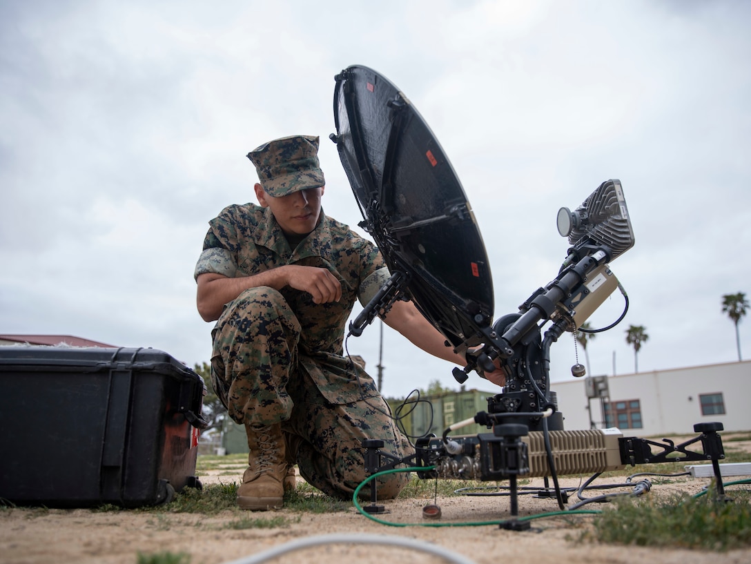 U.S. Marine Corps Lance Cpl. Ricardo Ramirez, a radio operator assigned to the 15th Marine Expeditionary Unit, I Marine Expeditionary Force, operates a multi-mission terminal (MMT)   during a command post exercise on Marine Corps Base Camp Pendleton, April 23, 2025. The MMT is a rapidly deployable, software-defined system that provides broadband connectivity across multiple satellite networks, enabling secure communications in support of expeditionary operations. The CPX allowed the 15th MEU to develop best practices for command and control of forces from a shore-based location to test systems, evaluate processes, develop techniques, and validate standard operating procedures. (U.S. Marine Corps photo by Sgt. Patrick Katz)