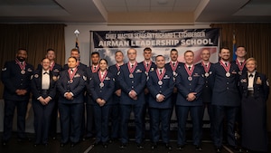 Airmen assigned to the 319th Reconnaissance Squadron pose for a photo after an Airman Leadership School ceremony at Grand Forks Air Force Base, N.D., March 27, 2025.