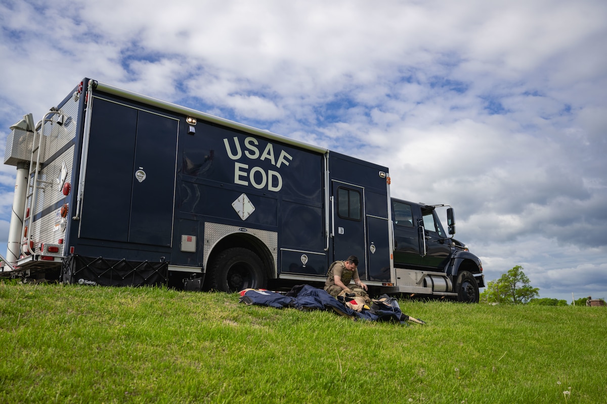 An Airman prepares to put on an EOD bomb suit.