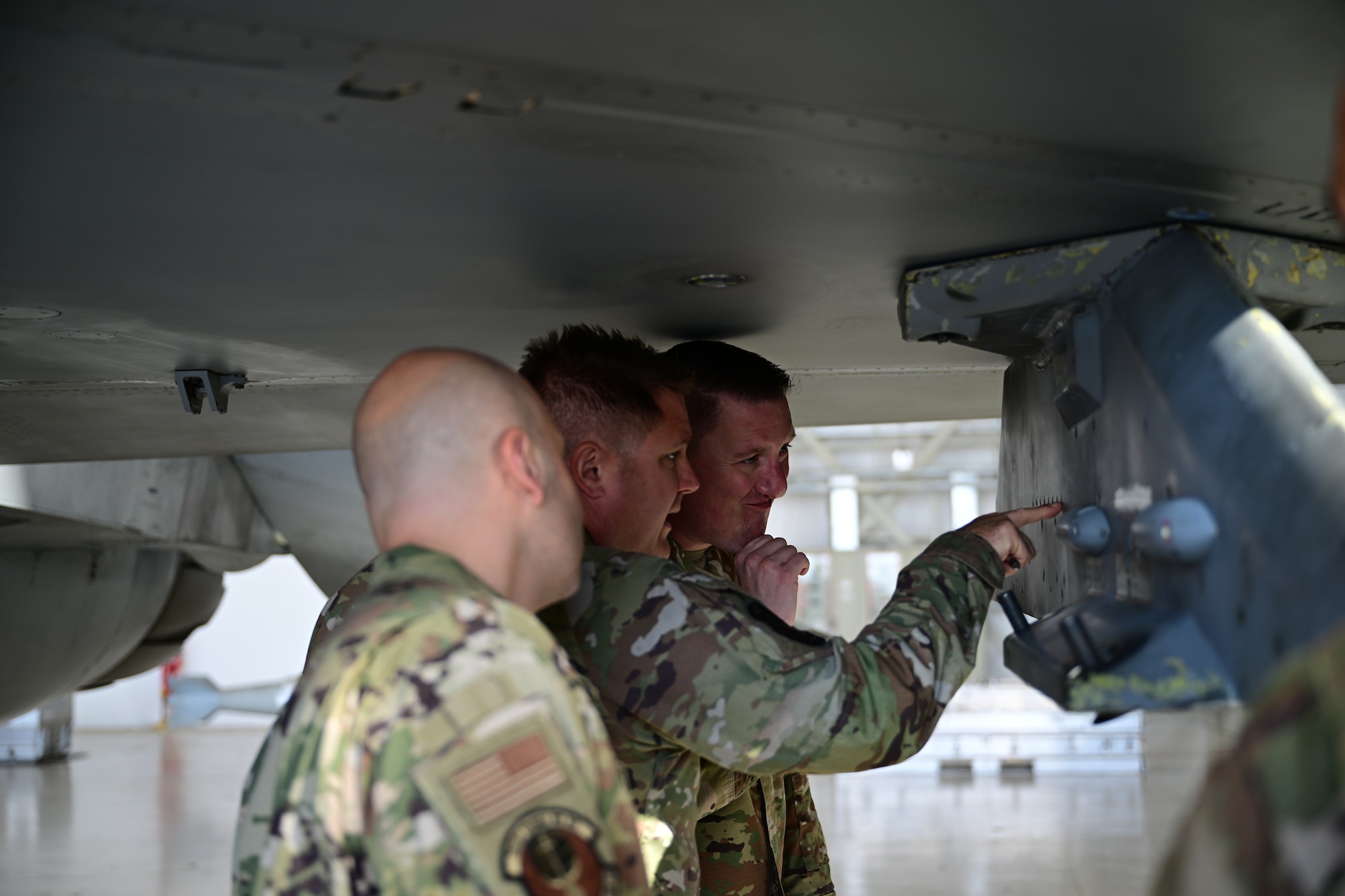U.S. Airmen inspect an aircraft.