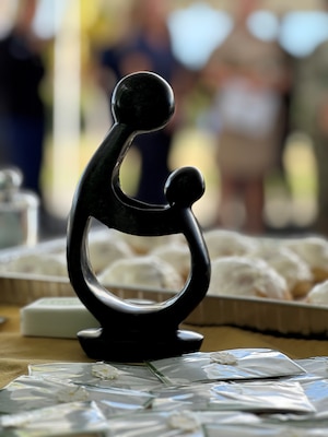 Three “Healer’s Touch” sculptures were presented during The DAISY Award ceremony that took place at U.S. Naval Hospital Guantanamo Bay, May 13, 2025.  The statue is a hand-carved stone sculpture given to nurses as part of the DAISY Foundation's recognition program. It symbolizes the special relationship between a nurse and their patient and is a reminder of the nurses' compassion and care.  (U.S. Navy photo by Emily McCamy/released)