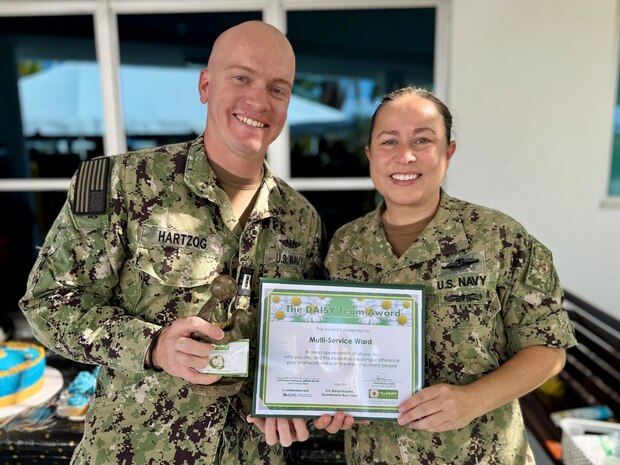 Lt. Lowell Hartzog, a surgical-medical nurse accepted the DAISY Team Award on behalf of the Multi-Service Ward nursing staff at U.S. Naval Hospital Guantanamo Bay, May 13, 2025. The award was established by The DAISY Foundation to recognize the extraordinary work of nurses worldwide. This was the second time in two years that MSW earned the award. (U.S. Navy photo by Emily McCamy/released)