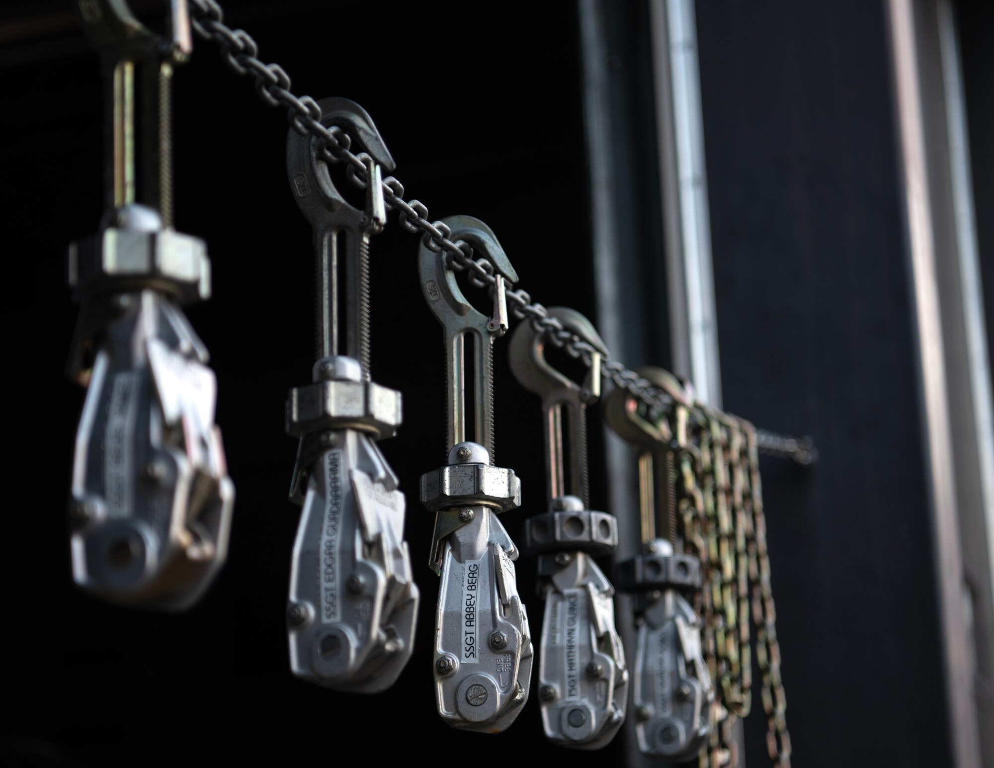 Cargo tie-down devices hang in honor of fallen aerial port members in St. Paul, Minn, May 4, 2025.
