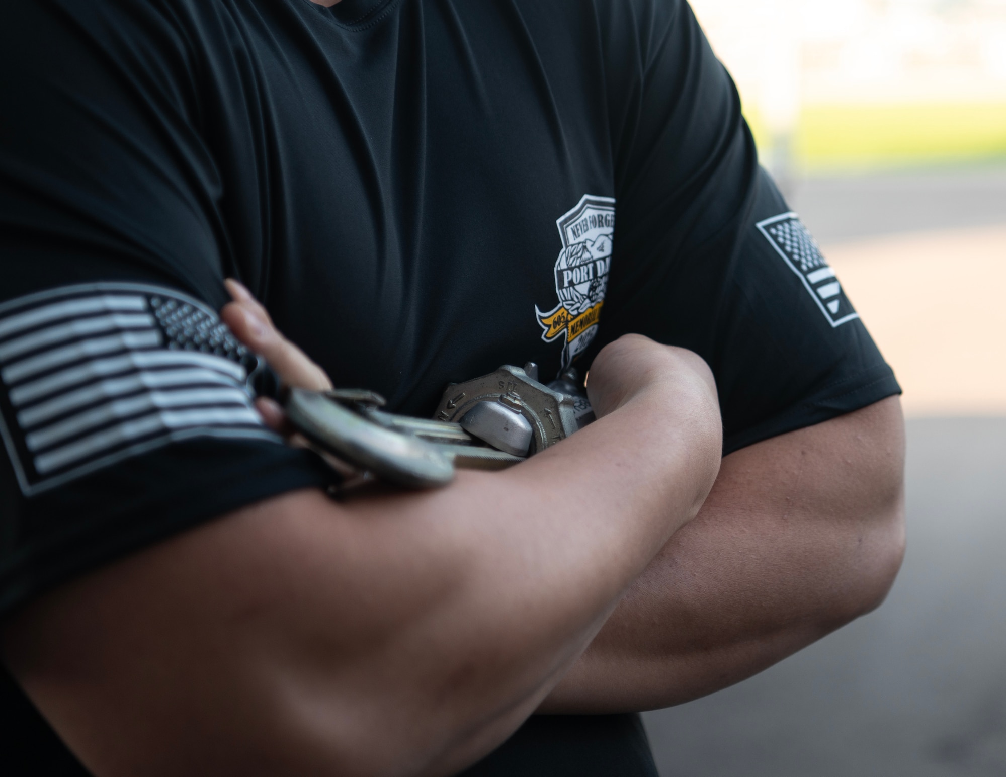 U.S. Air Force Airman from the 133rd Air Transportation Function holds a cargo tie-down device that has the name of a fallen aerial port member in St. Paul, Minn, May 4, 2025.