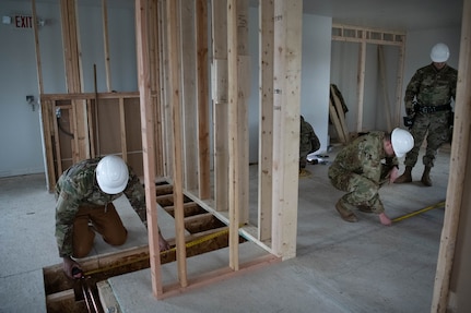 Airmen with the 138th Civil Engineer Squadron take measurements while doing a renovation project at the Seward Military Resort boathouse in Seward, Alaska, April 16, 2025. The 138th CES traveled to Seward as a part of a deployment for training, where they simultaneously completed training objectives and provided the facility with much needed renovations. (Oklahoma Air National Guard Photo by Master Sgt. Rebecca Imwalle)