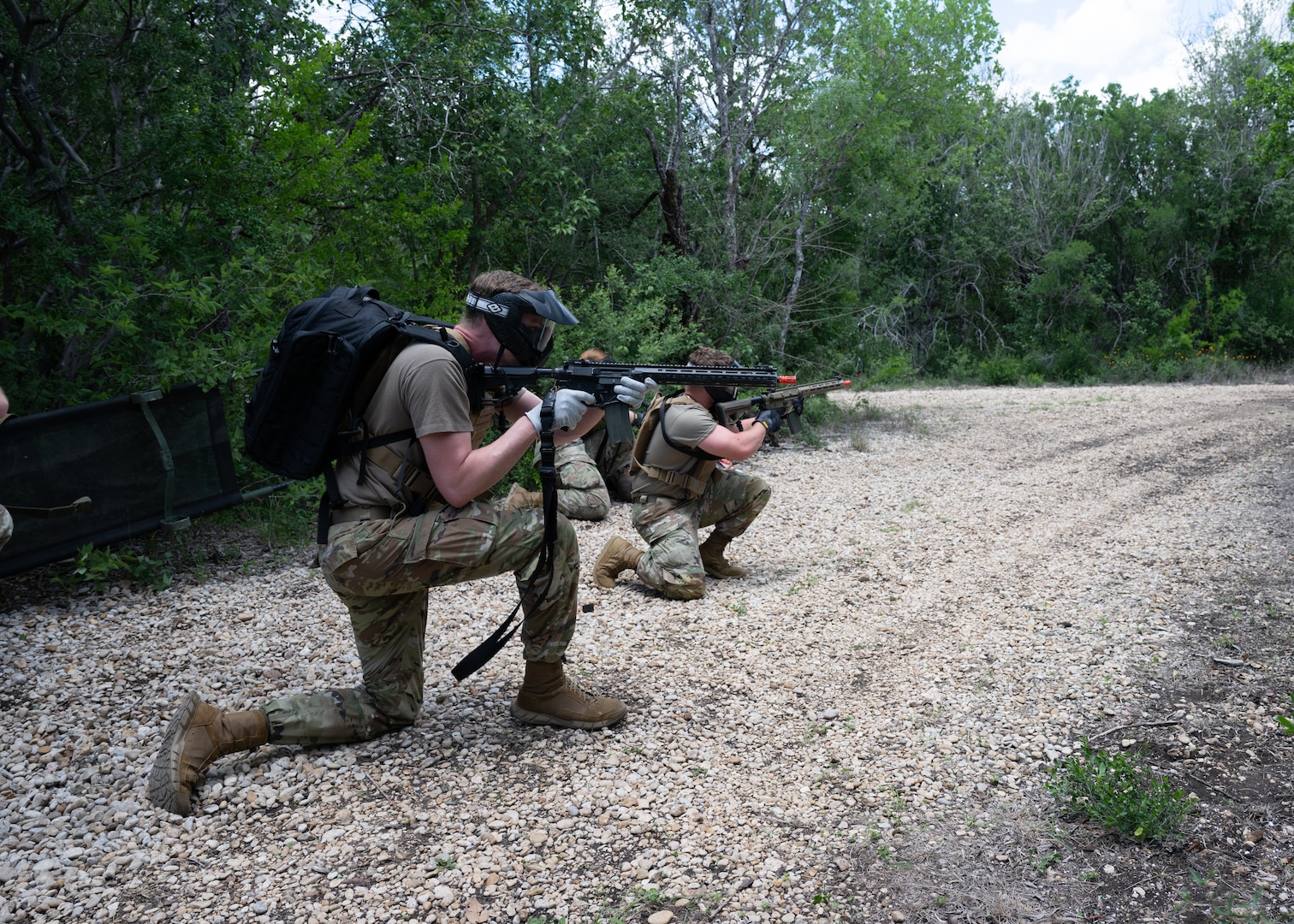 U.S. Air Force Airmen tends to asimulated  casualty under simulated fire during Tactical Combat Casualty Care Skills Day, held May 9, 2025, at Joint Base San Antonio-Lackland, Texas.
