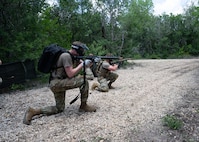 U.S. Air Force Airmen tends to asimulated  casualty under simulated fire during Tactical Combat Casualty Care Skills Day, held May 9, 2025, at Joint Base San Antonio-Lackland, Texas.