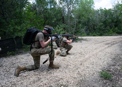 U.S. Air Force Airmen tends to asimulated  casualty under simulated fire during Tactical Combat Casualty Care Skills Day, held May 9, 2025, at Joint Base San Antonio-Lackland, Texas.