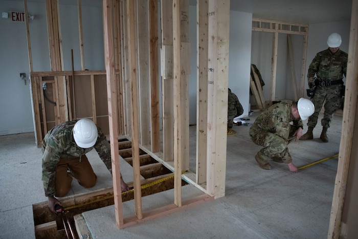 Airmen with the 138th Civil Engineer Squadron take measurements while doing a renovation project at the Seward Military Resort boathouse in Seward, Alaska, April 16, 2025. The 138th CES traveled to Seward as a part of a deployment for training, where they simultaneously completed training objectives and provided the facility with much needed renovations. (Oklahoma Air National Guard Photo by Master Sgt. Rebecca Imwalle)