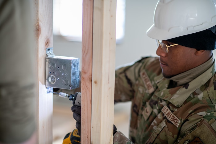 Airman 1st Class Christian McFarland, 138th Civil Engineer Squadron, installs an electrical box during a deployment for training at the Seward Military Resort boathouse in Seward, Alaska, April 14, 2025. The DFT consisted of several construction aspects, including building walls, laying concrete, installing electrical work and plumbing. (Oklahoma Air National Guard Photo by Master Sgt. Rebecca Imwalle)