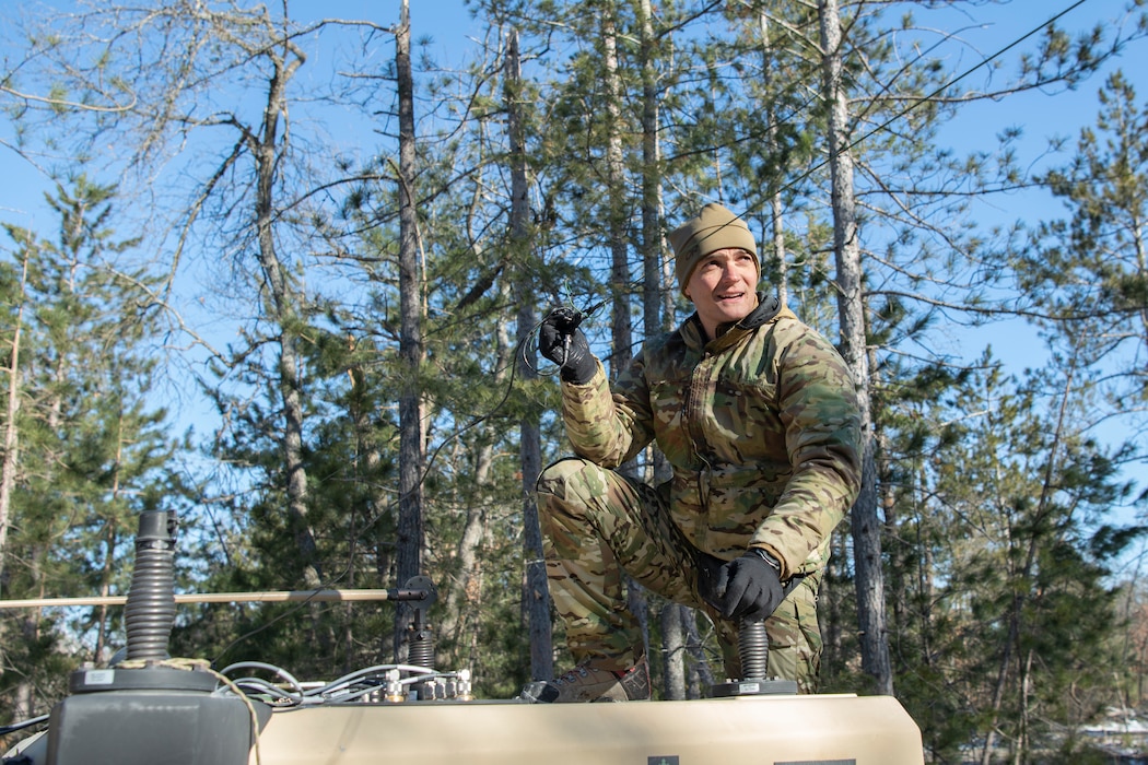 Airman sets up communications equipment