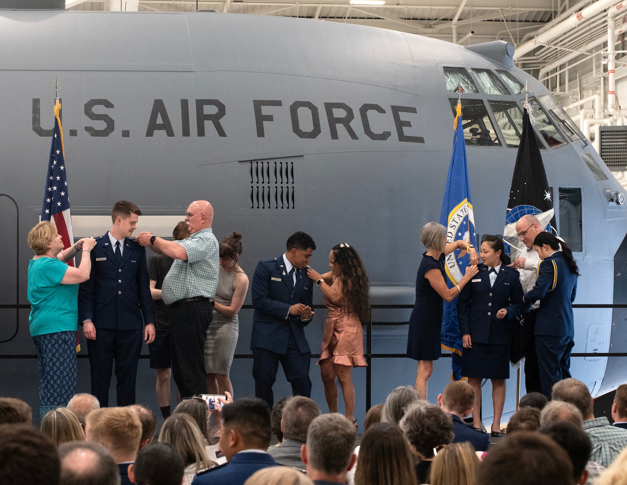 Family and friends of cadets from the University of Minnesota’s Air Force Reserve Officer Training Corps Det. 415, pin on their new rank of 2nd lieutenant in St. Paul, Minn., May 13, 2025.