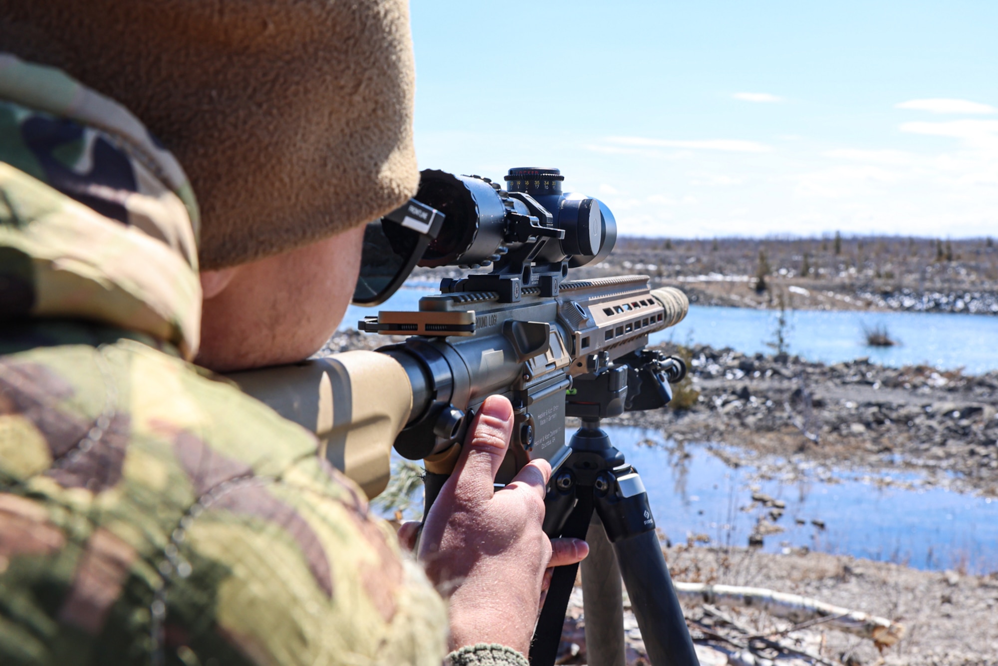 An Airman looks down a scope