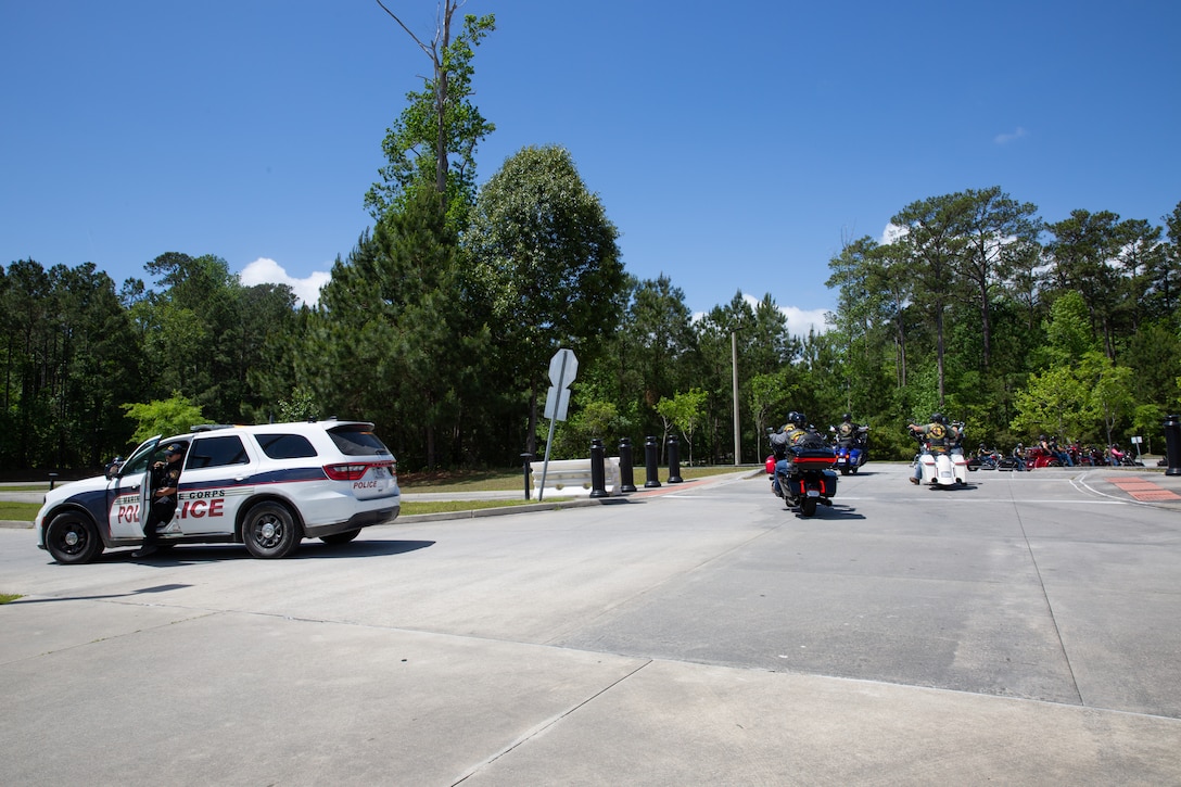 Civilians from the Combat Veteran’s Motorcycle Association arrive at Wallace Creek Fitness Center during the Operation Never Forget flag display on Marine Corps Base Camp Lejeune, North Carolina, May 3, 2025. The flag serves as a powerful tribute to our fallen heroes. Service members are encouraged to sign it and add their unit patches as a symbol of unity, remembrance, and unwavering commitment to honor those who made the ultimate sacrifice. (U.S. Marine Corps photo by Lance Cpl. Devaraja Renshaw)