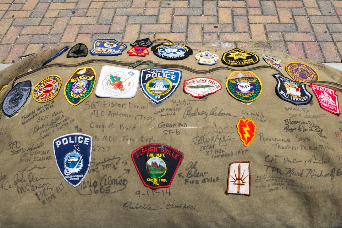 A seabag containing the 9/11 Memorial Flag is delivered at Wallace Creek Fitness Center on Marine Corps Base Camp Lejeune, North Carolina, May 3, 2025. The flag serves as a powerful tribute to our fallen heroes. Service members are encouraged to sign it and add their unit patches as a symbol of unity, remembrance, and unwavering commitment to honor those who made the ultimate sacrifice. (U.S. Marine Corps photo by Lance Cpl. Devaraja Renshaw)