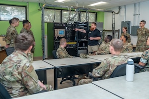 An instructor showing equipment to Airmen.