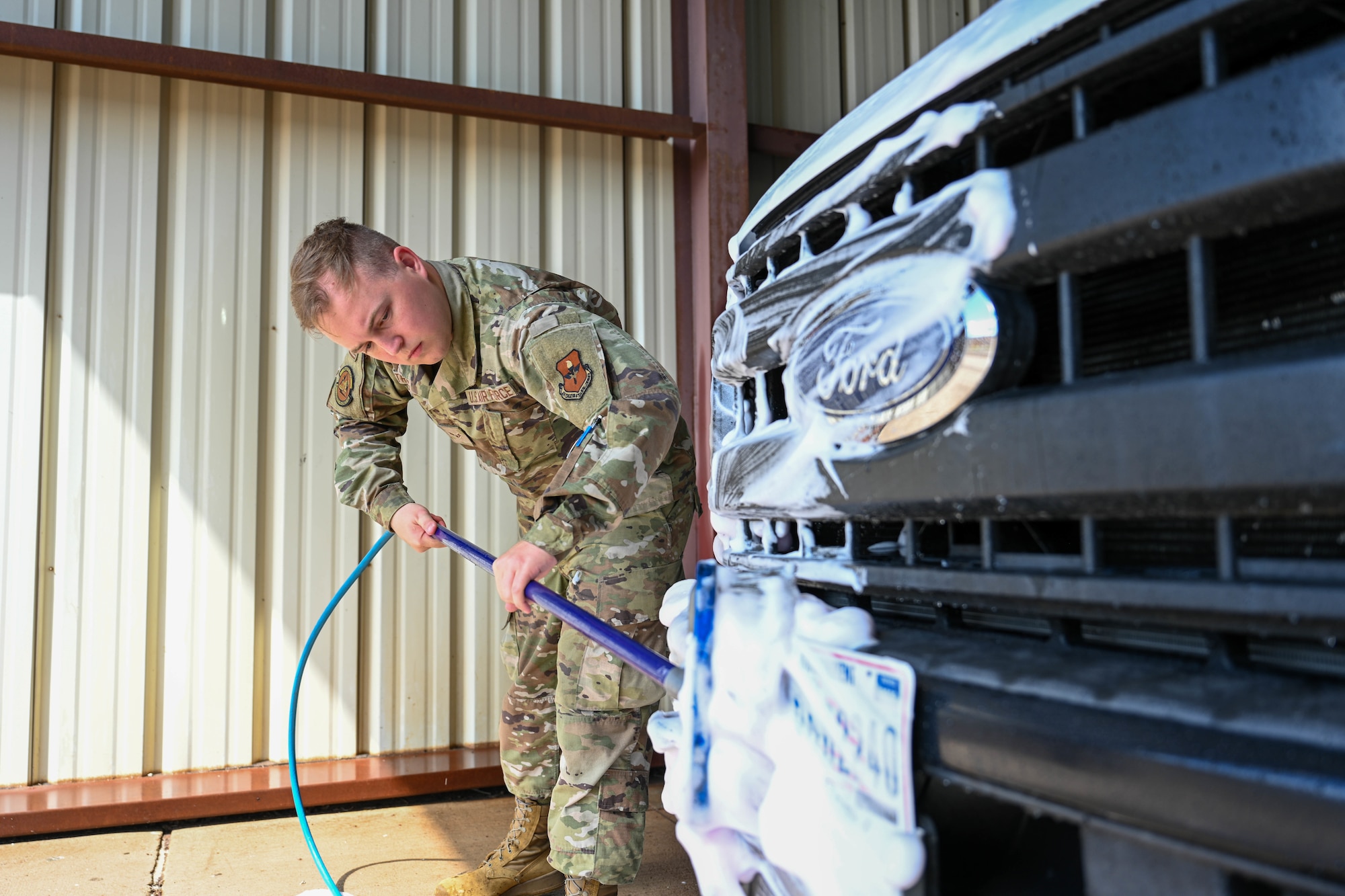 U.S. Air Force Airman 1st Class Ashton Trumps, 97th Logistics Readiness Squadron ground transportation operator, scrubs the front of a government-owned vehicle at Altus Air Force Base, Oklahoma, May 8, 2025. The 97th Air Mobility Wing’s vehicles are used for a variety of reasons, including lending to distinguished visitors, providing rides for Airmen and hauling fuel for our aircraft. (U.S. Air Force photo by Airman 1st Class Lauren Torres)