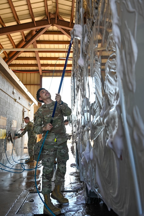 U.S. Air Force Airman Ayden Delgado, 97th Logistics Readiness Squadron ground transportation operator, washes a government-owned vehicle at Altus Air Force Base, Oklahoma, May 8, 2025. The base’s vehicle wash rack, inactive since 2023, recently reopened to support the upkeep and mission readiness of government-owned vehicles. (U.S. Air Force photo by Airman 1st Class Lauren Torres)