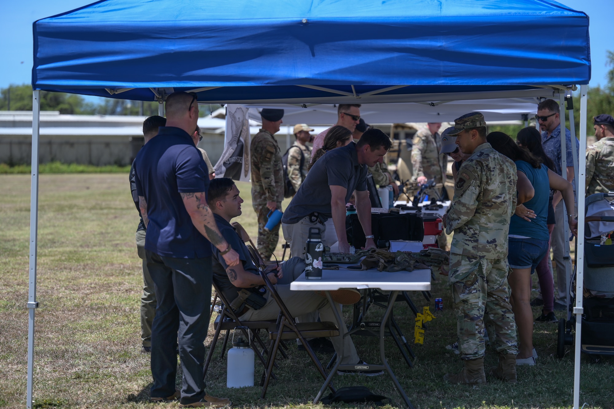 Military police representatives stand at several booths.