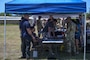 Military police representatives stand at several booths.
