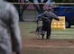 A military working dog bites a decoy.