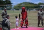 Sailors demonstrate redman baton training to a toddler.