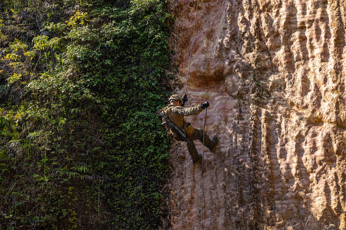 A U.S. Marine rappels during Jungle Leaders Course at the Jungle Warfare Training Center, Okinawa, Japan, May 02, 2025.