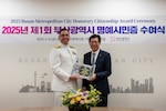 BUSAN, Republic of Korea (May 9, 2025) – U.S. Navy Rear Adm. Neil Koprowski, Commander, U.S. Naval Forces Korea (CNFK), left, receives a Busan Metropolitan City Honorary Citizenship Award from Mayor Park, Heong-joon, at Busan’s International Exhibition Hall of City Hall, May 9, 2025, Republic of Korea. The Honorary Citizenship Award recognizes individuals, and foreigners in particular, who have made significant contributions to Busan City’s cultural, social or economic development. CNFK is the U.S. Navy’s representative in Republic of Korea, providing leadership and expertise in naval matters to improve institutional and operational effectiveness between the two navies and to strengthen collective security efforts in Republic of Korea and the region. (U.S. Navy photo by Mass Communications Specialist 1st Class Desmond Parks)