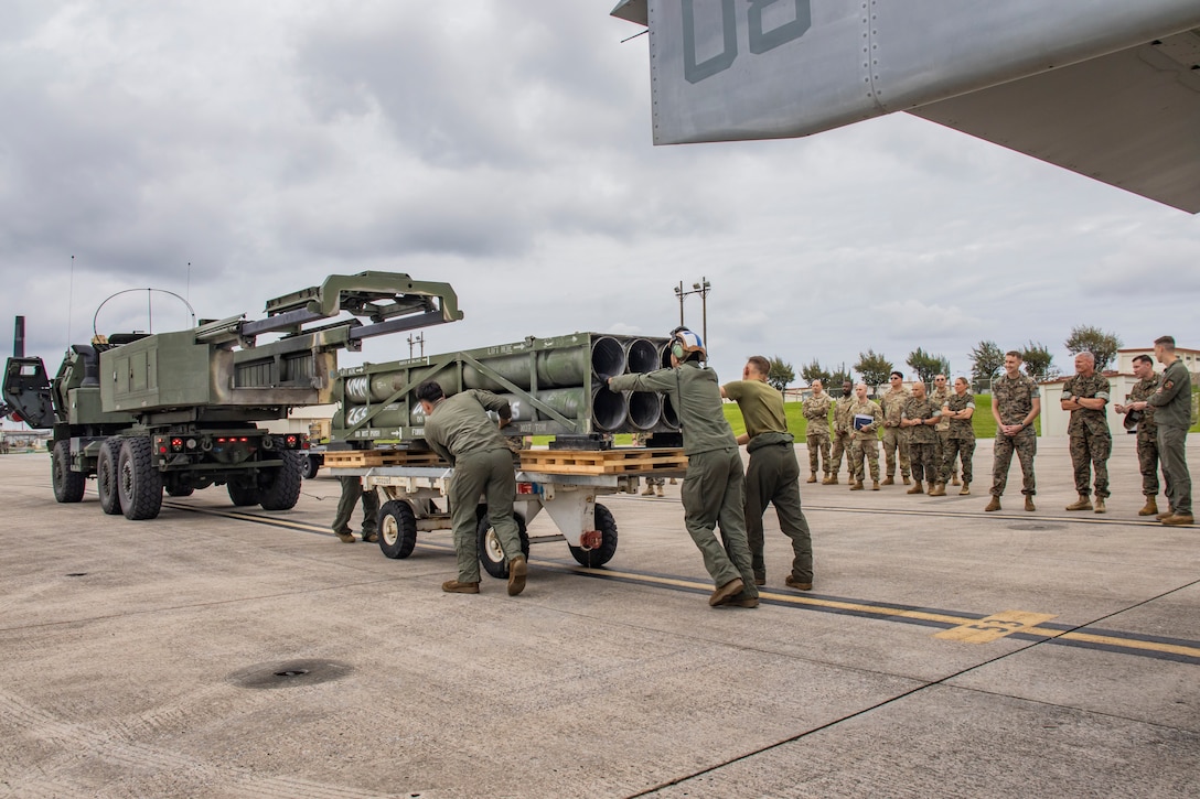 U.S. Marines with Marine Medium Tiltrotor Squadron 265 (Rein.), 31st Marine Expeditionary Unit, conduct a M142 High Mobility Artillery Rocket System ammunition reload demonstration for senior leaders with III Marine Expeditionary Force, and U.S. Army soldiers with Delta Battery, 1st Battalion, 1st Air Defense Artillery Regiment, 38th Air Defense Artillery Brigade, during a commanding general visit at Marine Corps Air Station Futenma, Okinawa, Japan, May 12, 2025. Lt. Gen. Roger Turner visited Marines with the 31st MEU to give recognition for various accomplishments and to observe equipment demonstrations. The 31st MEU, the Marine Corps’ only continuously forward-deployed MEU, provides a flexible and lethal force ready to perform a wide range of military operations as the premiere crisis response force in the Indo-Pacific region. (U.S. Marine Corps photo by Sgt. Tyler Andrews)