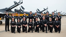 American and South Korean military members take a group photo in front of T-50 jets