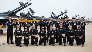 American and South Korean military members take a group photo in front of T-50 jets
