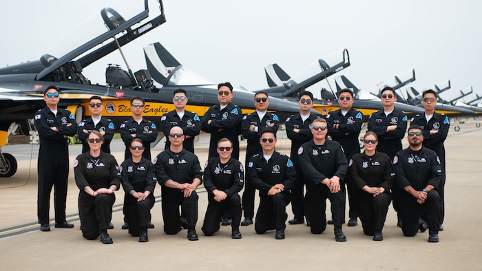 American and South Korean military members take a group photo in front of T-50 jets