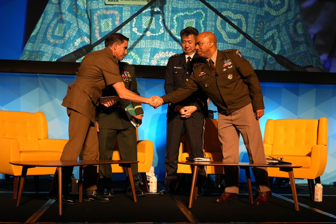 Panelists shake hands at the conclusion of a discussion on combined and joint campaigning during the Land Forces Pacific (LANPAC) Symposium and Exhibition in Honolulu, Hawaii, May 14, 2025.