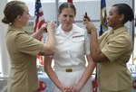 Shouldering the responsibility…Lt. Halle Hassett, assigned to NMRTC Bremerton, is ably assisted by fellow Navy Nurse Corps officers Lt. Jill Becker (left) and Lt. Mikala Tracy in adding her shoulder boards upon being officially promoted to the Navy rank of lieutenant as part of the command’s recognition of 117 year anniversary of the Navy Nurse Corps and their corps – from ensign to admiral - commitment to mission readiness (Official Navy photo by Douglas H Stutz, NHB/NMRTC Bremerton public affairs officer).