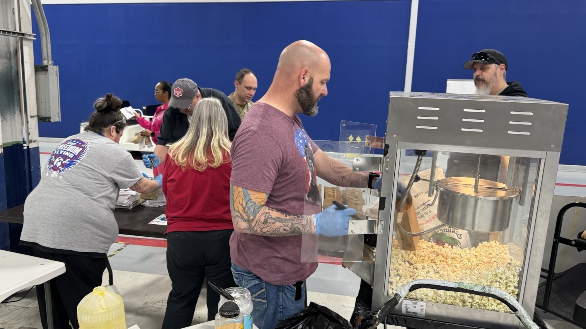 several people setting up a popcorn social event