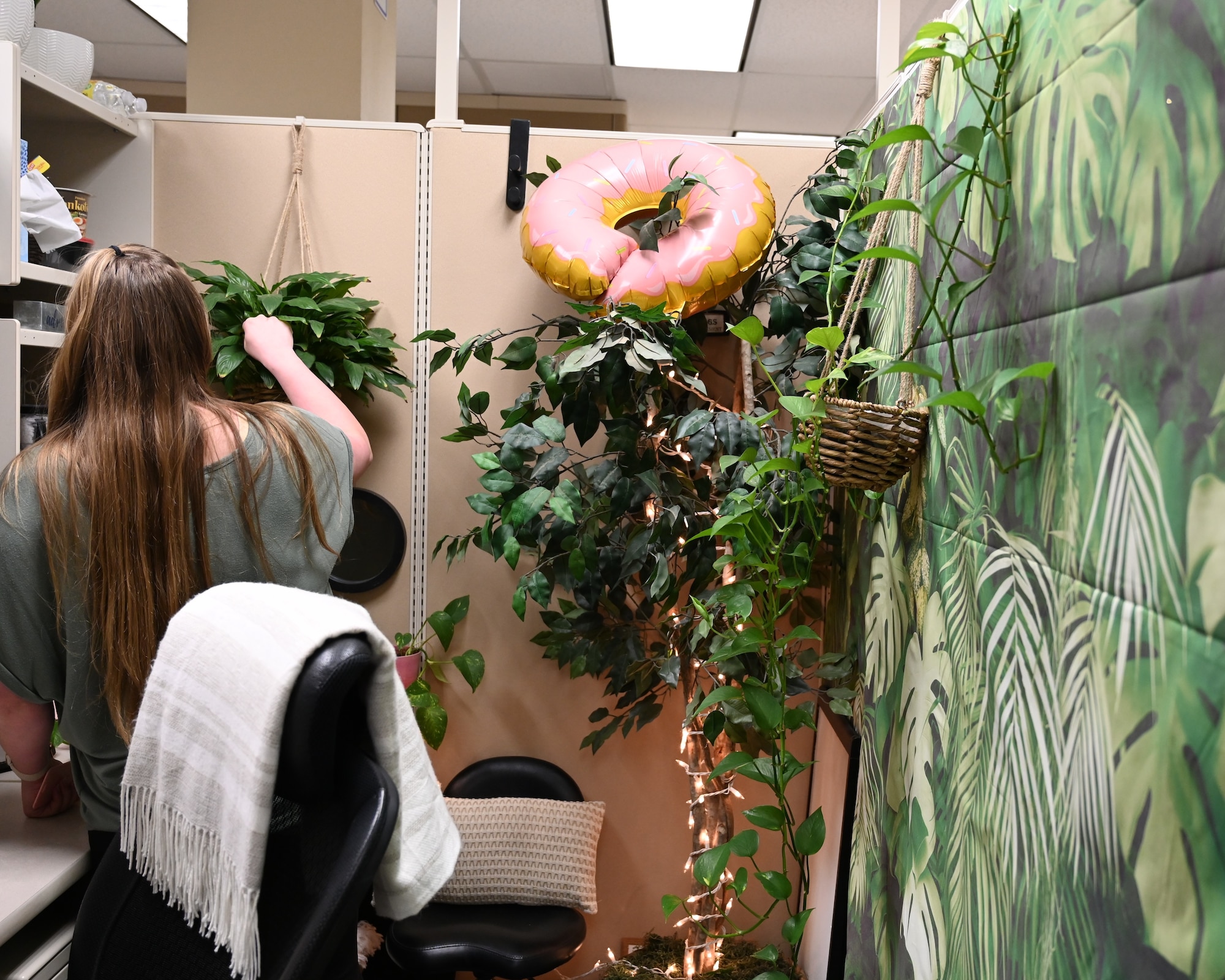 a woman watering her plant