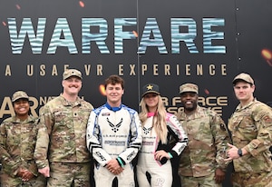 Branden and Amanda Sorensen, Air Force Recruiting Service, sponsored motorsports athletes pose for a photo with Airmen from the 331st Recruiting Squadron at Formula Drift Atlanta May 10,2025.
