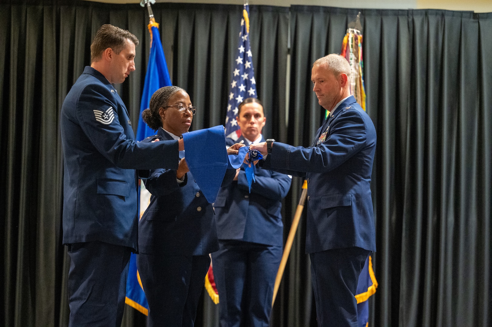 Brig. Gen. Gwendolyn A. Foster, 59th Medical Wing commander, and Col. Brian Caruthers, 937th Training Group commander, sheath the 59th Training Group guidon during the deactivation and activation ceremony for the 937th Training Group on May 13, 2025, at Joint Base San Antonio-Fort Sam Houston, Texas.  The 937th Training Group is responsible for training 19 Air Force Medical Specialties across four squadrons and 39 geographically separated locations, offering 68 formal courses to develop the next generation of medical professionals. (U.S. Air Force photo by 2nd Lt Kate Anderson)