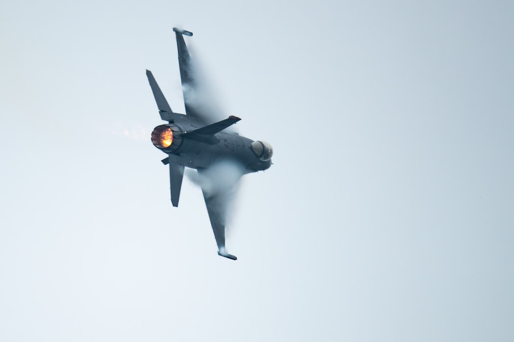 an F-16 fighter jet makes a sharp turn through the air